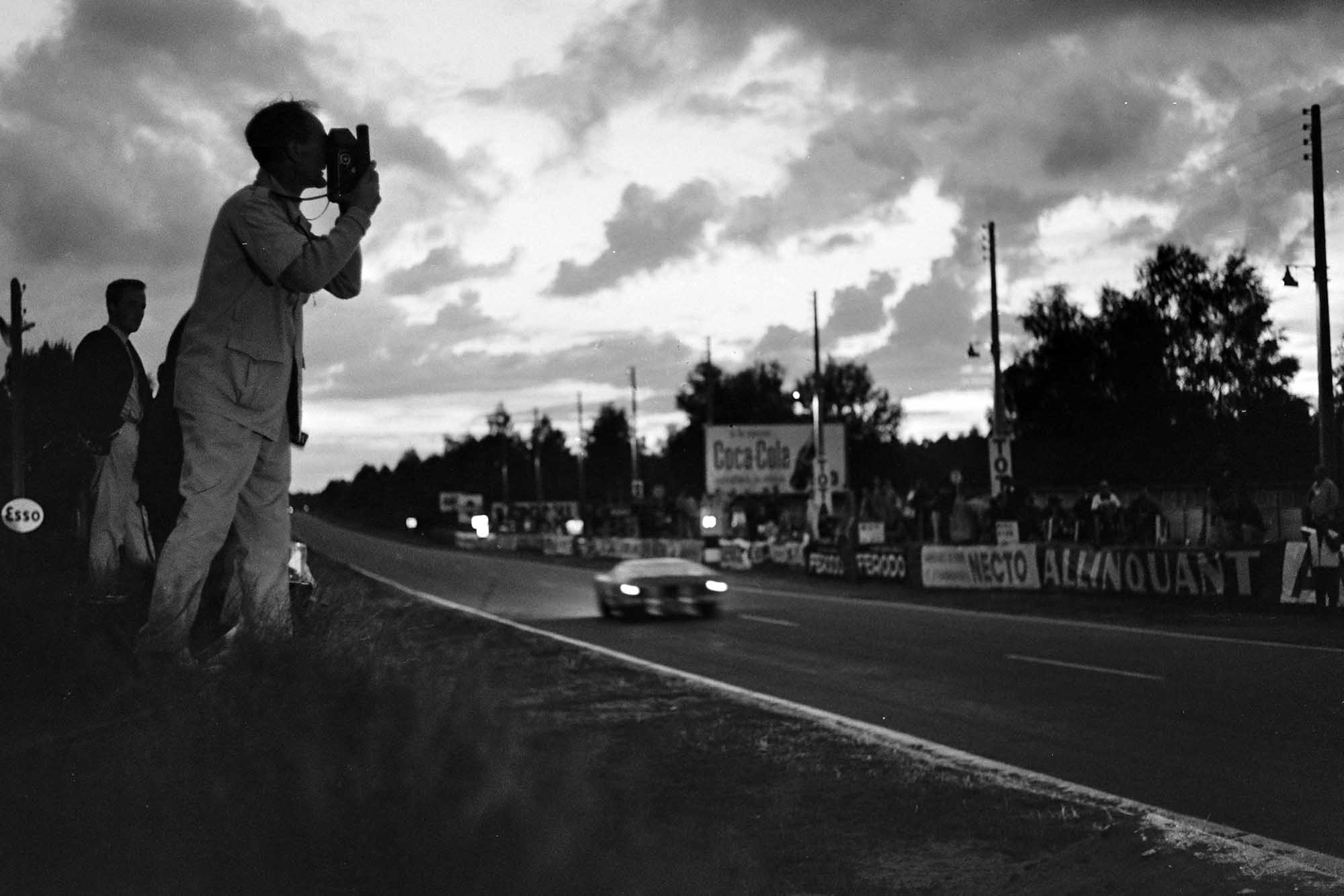 A photographer catches a passing Ford GT40 at dawn