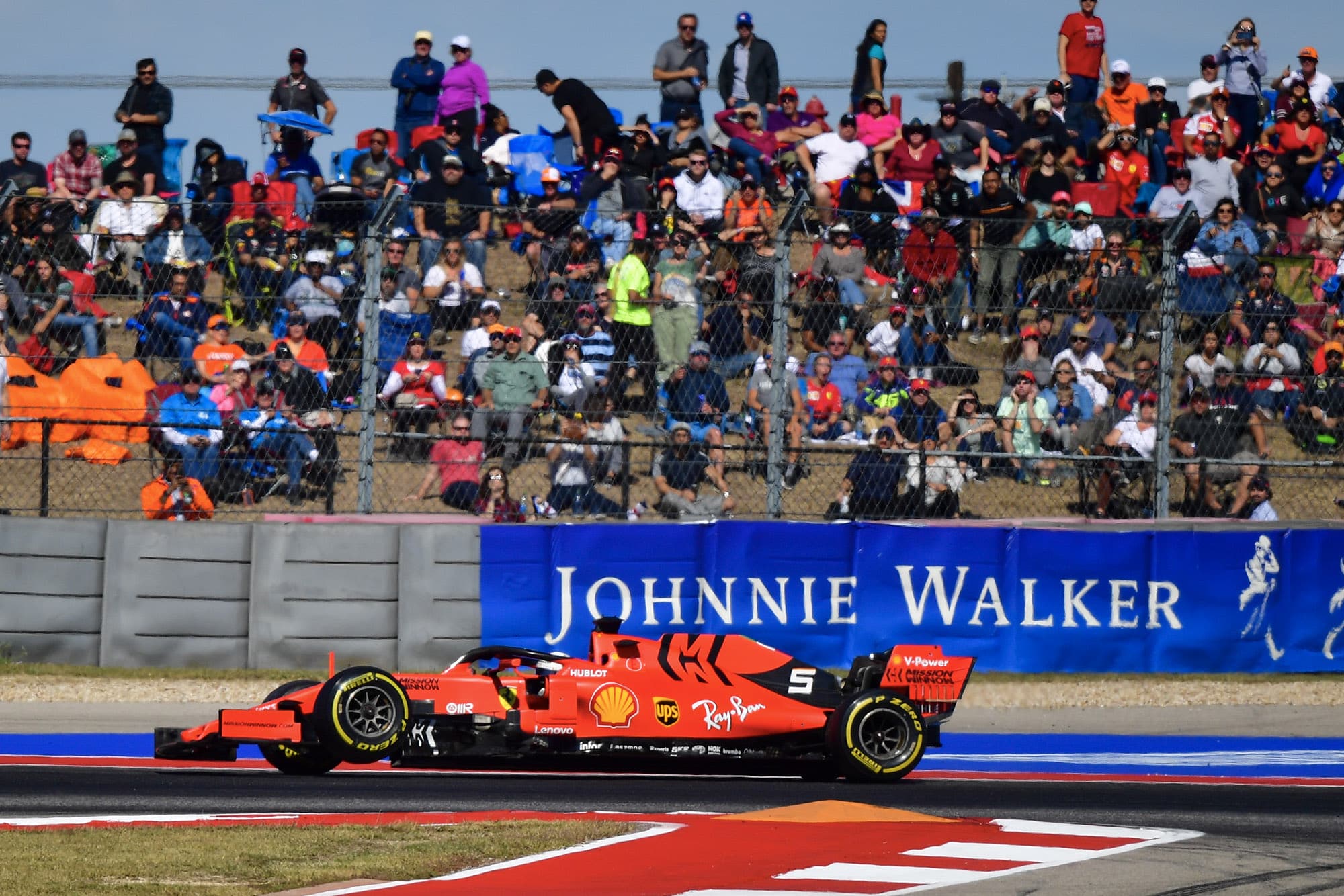 The left front wheel on Sebastian Vettel's Ferrari is raised in the air after his car suffered suspension failure