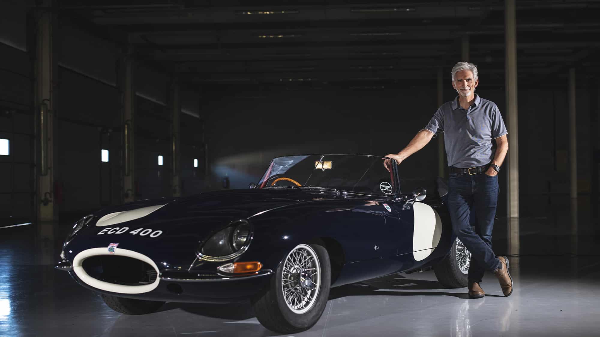 Damon Hill in pit garage with Graham Hill race-winning Jaguar E-type