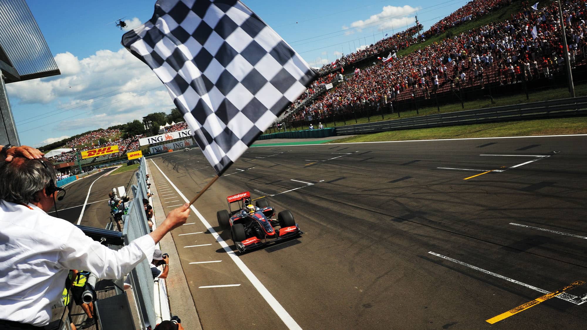 Lewis Hamilton drives past the chequered flag to win the 2009 Hungarian Grand Prix