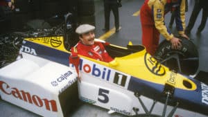 Nigel Mansell smiles in the cockpit of the Williams FW10