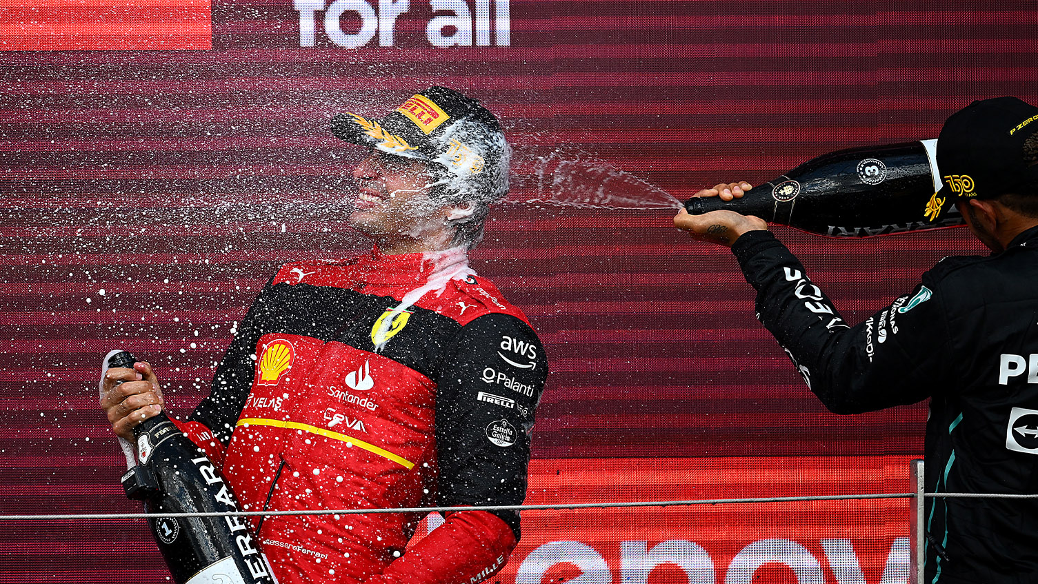 Lewis Hamilton sprays Carlos Sainz with champagne after the 2022 British Grand Prix