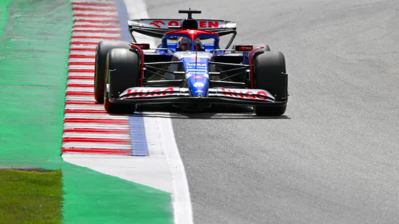 AlphaTauri F1 car drives over blue line between kerb and track edge at 2024 Spanish Grand Prix