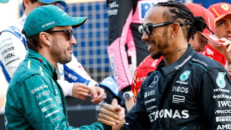 Lewis Hamilton shakes hands with Fernando Alonso ahead of the 2024 F1 season