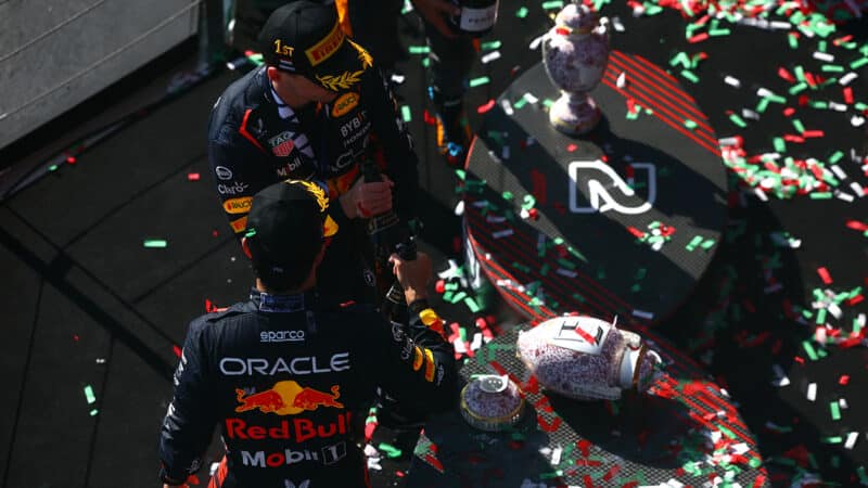 Max Verstappen and Sergio Perez look at broken trophy on the podium after 2023 F1 Hungarian Grand Prix