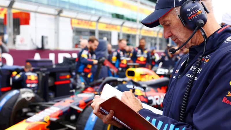 Adrian Newey writes in his red notebook on the grid at the 2024 F1 British Grand Prix