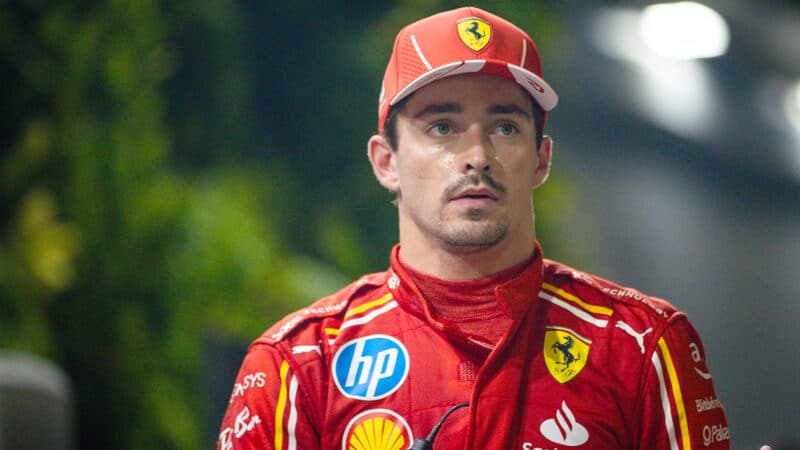 Charles Leclerc walks through the 2024 Singapore Grand Prix paddock after qualifying