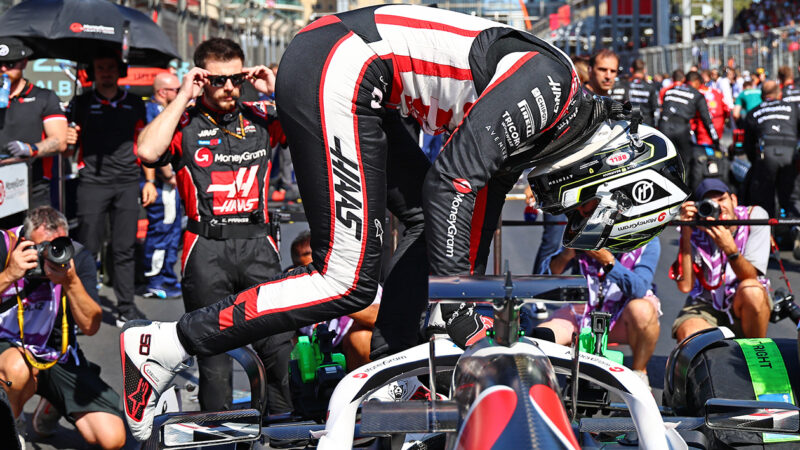 Oliver Bearman leaps into his Haas F1 car at the 2024 F1 Azerbaijan Grand Prix